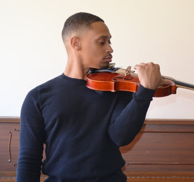 Adult Student focusing on playing violin
